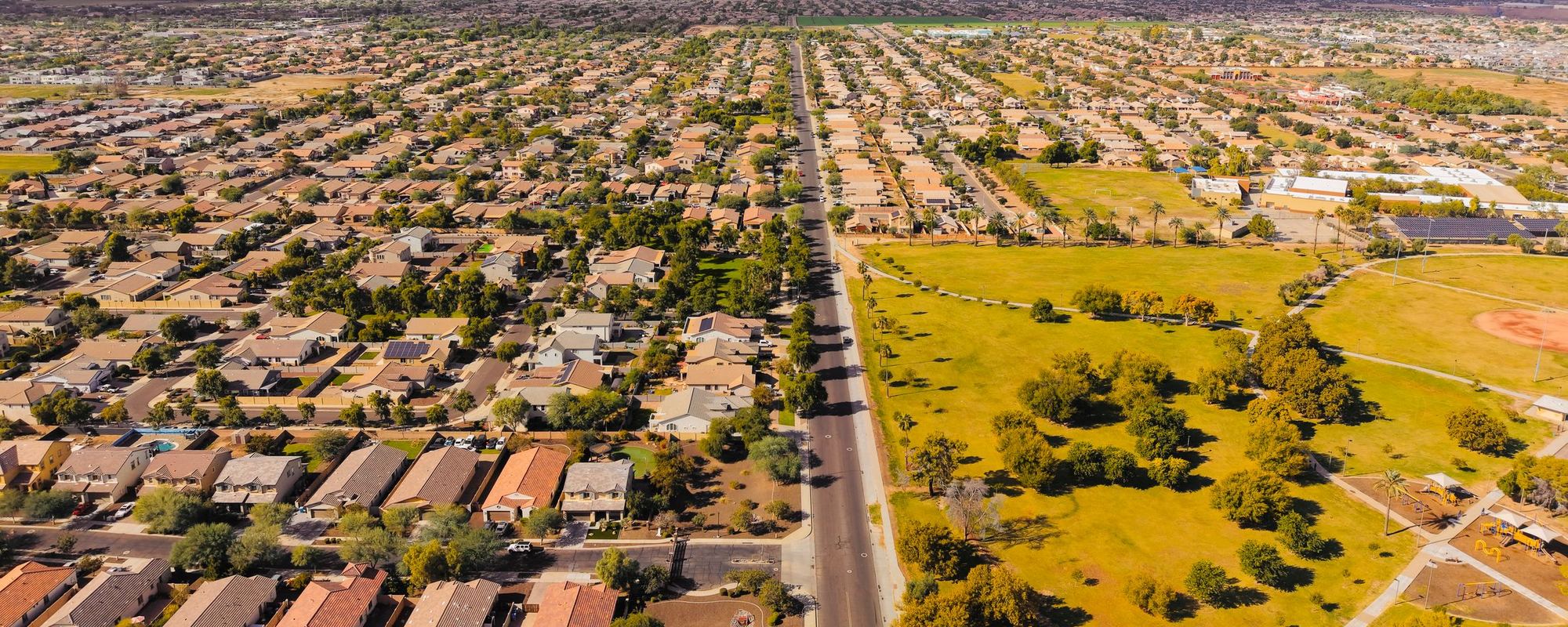 Aerial view of a suburb in Arizona with mountains behind