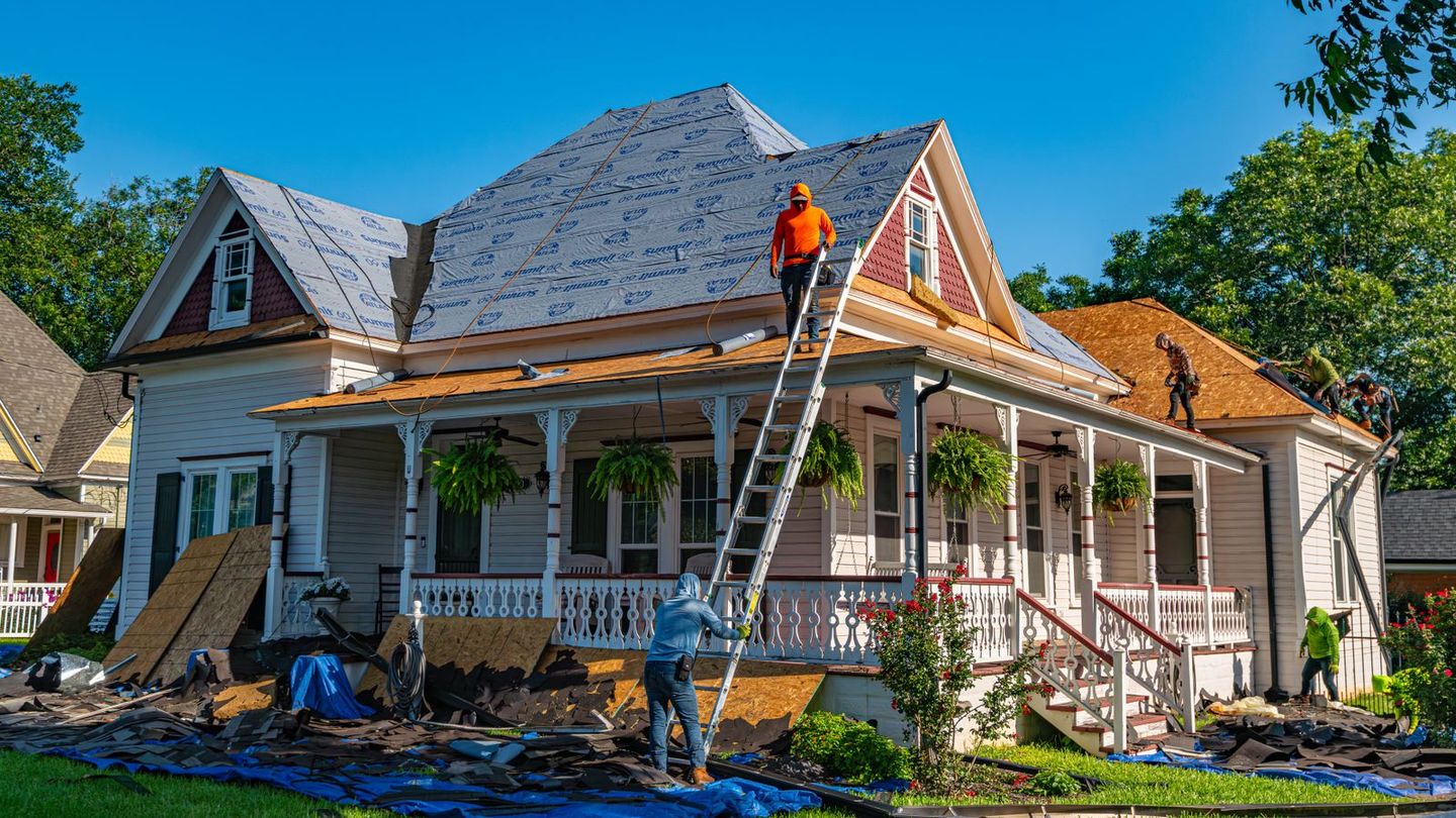 Crew replacing the roof of a historic two-story home
