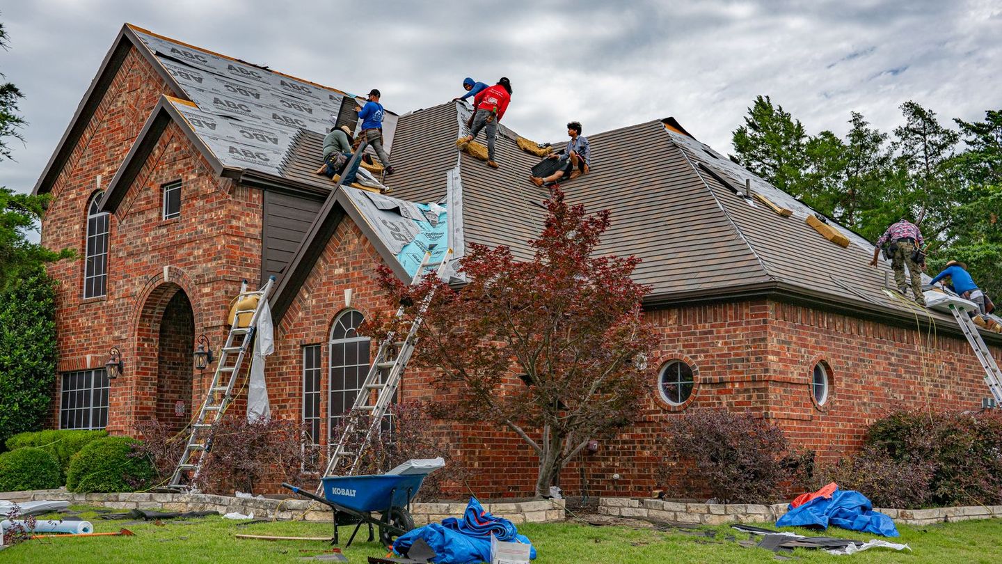 Crew replacing the roof of a brick house in North Texas
