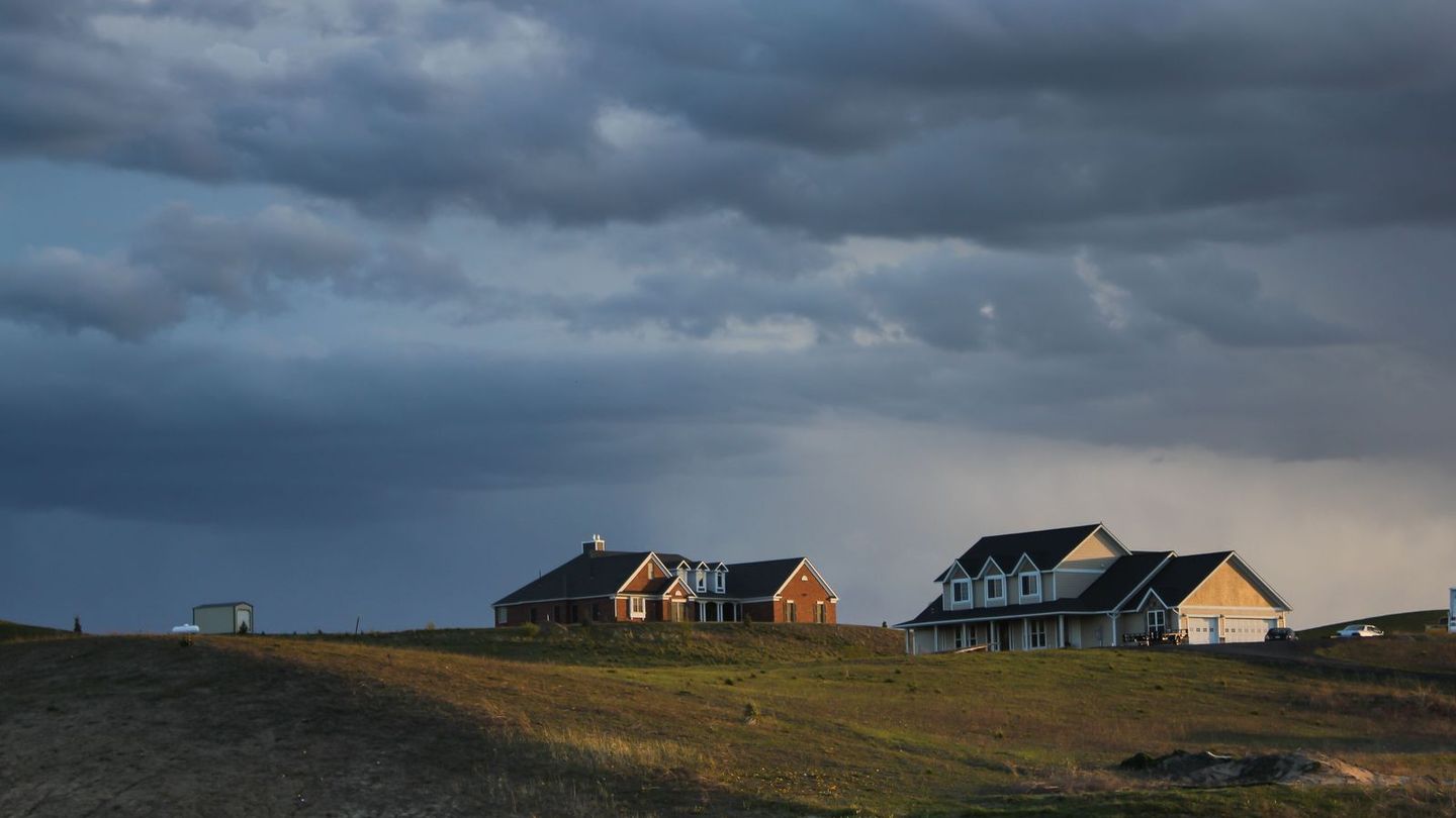 Storm clouds over houses on the edge of town